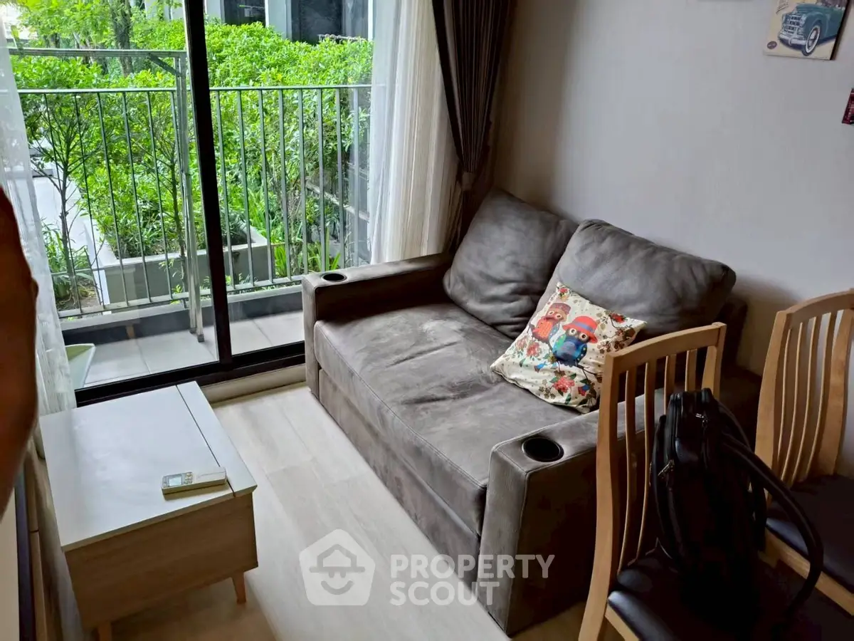 Cozy living room with sofa and balcony view in modern apartment