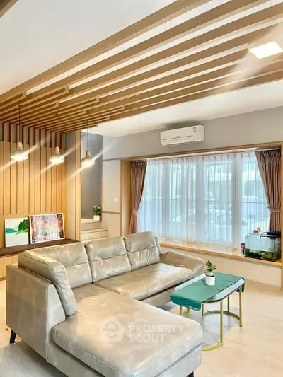 Modern living room with stylish ceiling design and cozy leather sofa