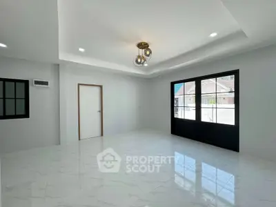 Spacious modern living room with elegant lighting and large windows