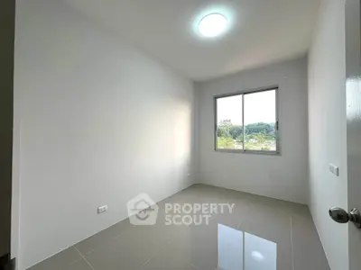 Spacious empty room with large window and glossy tiled floor, perfect for customization.