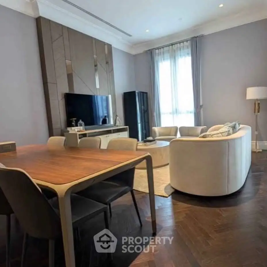 Elegant living room with modern furniture and large window, perfect for stylish urban living.