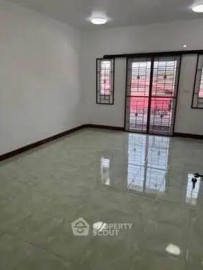 Spacious empty room with large windows and glossy tiled floor, perfect for customization.