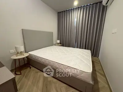 Modern bedroom with stylish decor and natural light, featuring a comfortable bed and elegant curtains.