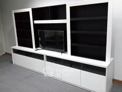 Modern living room with sleek white entertainment unit and TV