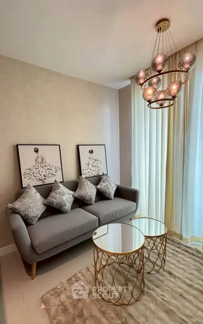 Stylish living room with modern sofa, chic chandelier, and elegant decor.