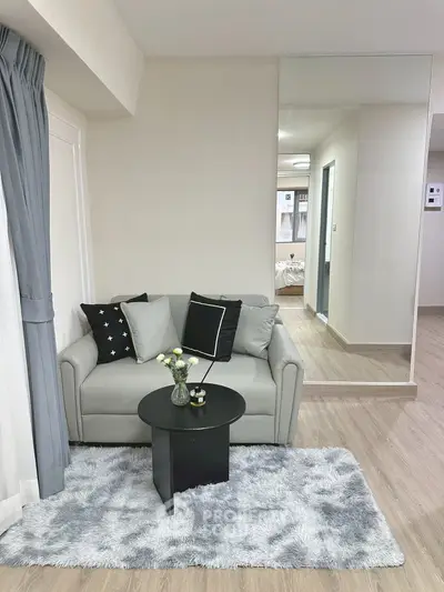 Modern living room with cozy gray sofa and stylish decor, perfect for urban living.