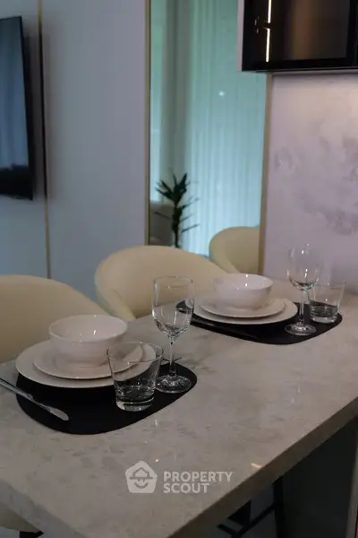 Modern kitchen with elegant dining setup on marble countertop