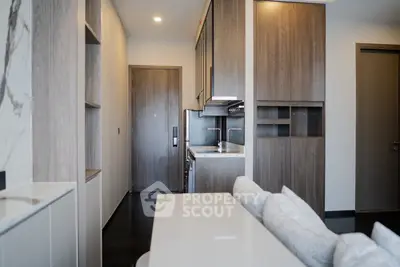Modern kitchen with sleek cabinetry and integrated appliances in a stylish apartment.