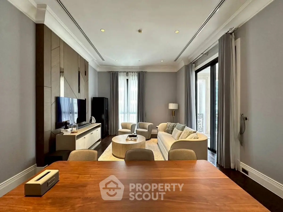 Luxurious living room with elegant decor and large windows offering natural light.