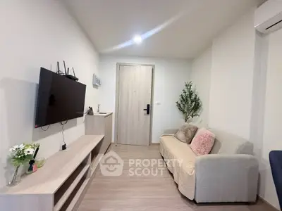 Modern living room with cozy sofa and wall-mounted TV in a stylish apartment.