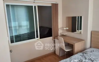 Cozy bedroom with study nook and modern decor in a stylish apartment.