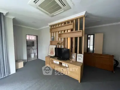 Spacious living room with modern wooden partition and built-in TV unit