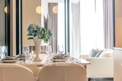 Elegant dining area with modern decor and natural light in a luxurious apartment.