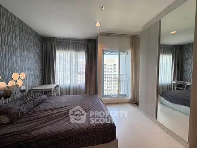 Modern bedroom with stylish decor and balcony view in urban apartment