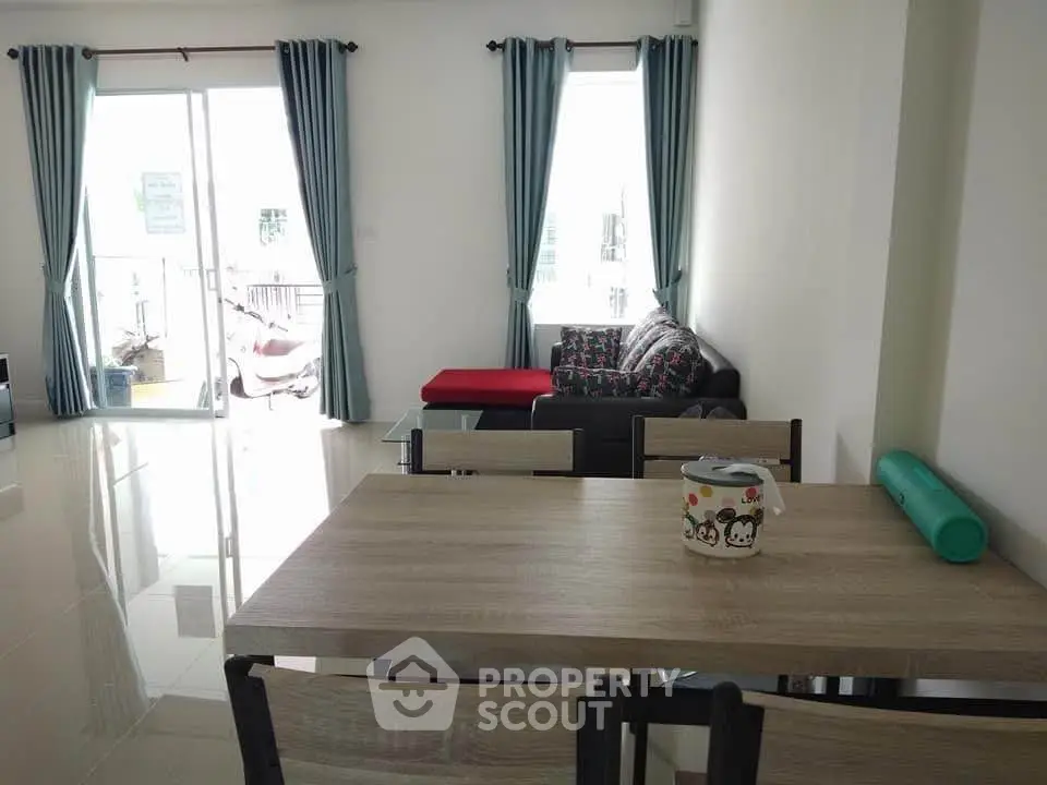 Spacious living room with modern furniture and large windows for natural light.