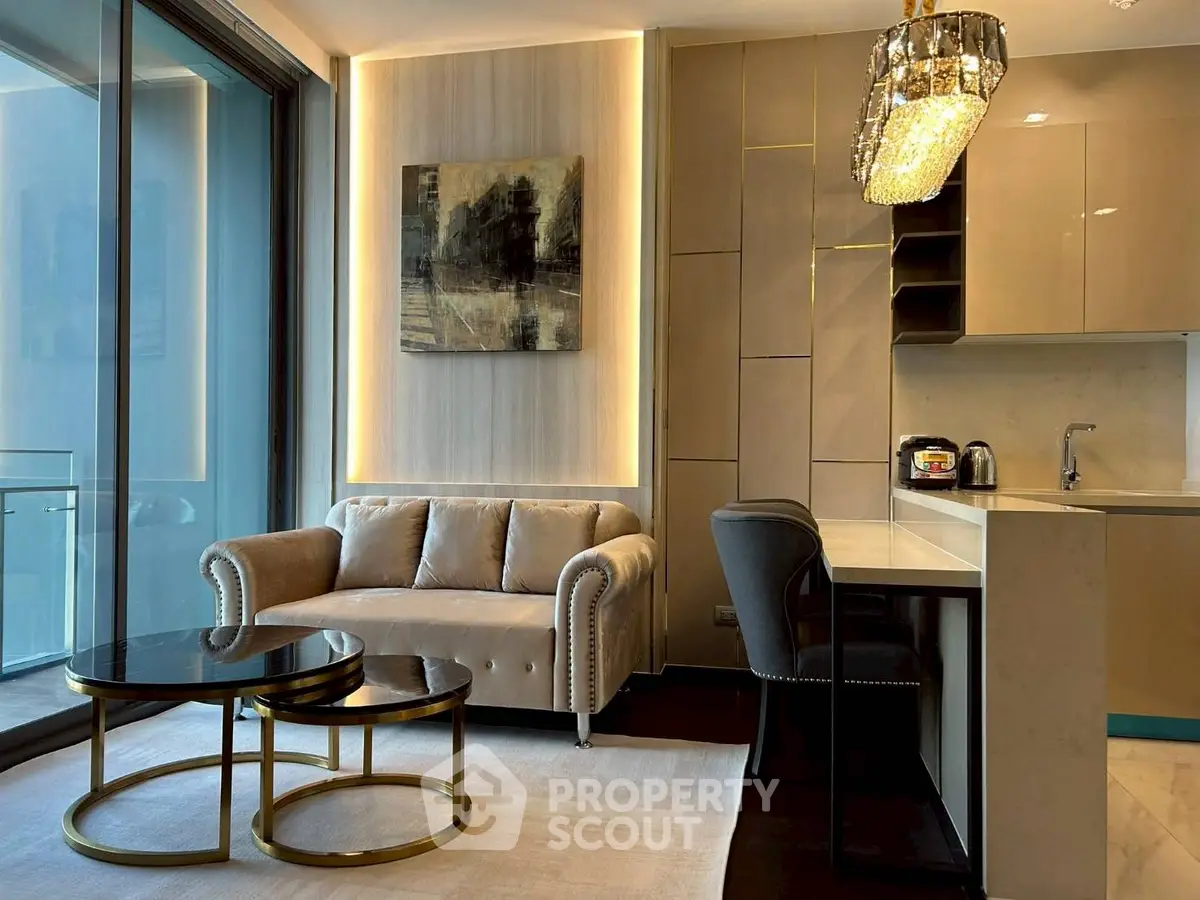 Luxurious modern living room with elegant sofa, chic lighting, and sleek kitchen area in open layout apartment.
