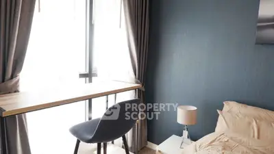 Modern bedroom with stylish desk and chair by large window, elegant decor