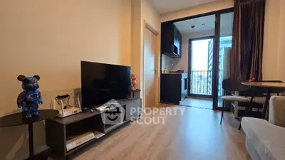 Modern living room with balcony view, stylish decor, and open layout in urban apartment.