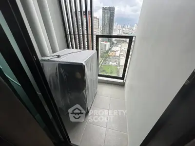 Modern balcony with city view and covered appliance, ideal for urban living.