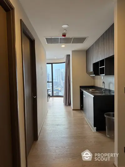 Modern apartment hallway with kitchen and city view