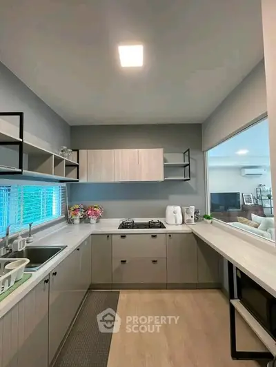 Modern kitchen with sleek cabinetry and gas stove in stylish apartment