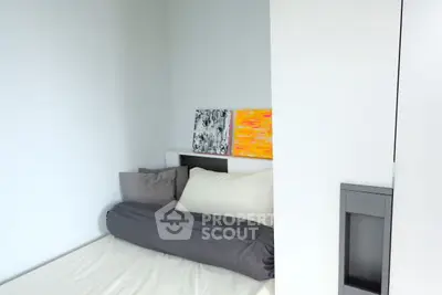 Cozy modern bedroom with artistic decor and plush bedding