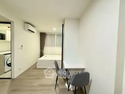 Modern studio apartment with minimalist design and cozy workspace