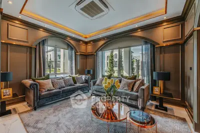 Luxurious living room with elegant decor and large windows offering a stunning view.