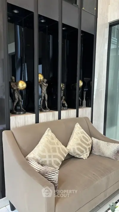 Luxurious modern living room with elegant sofa and artistic sculptures