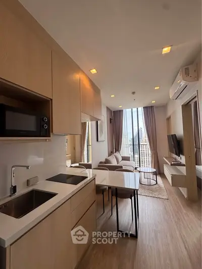 Modern open-layout kitchen and living room with city view in high-rise apartment