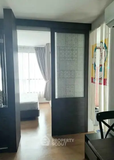 Modern apartment interior with sliding door and natural light