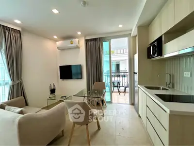 Modern living room with balcony access and sleek kitchen design