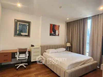 Spacious modern bedroom with stylish decor and large window view