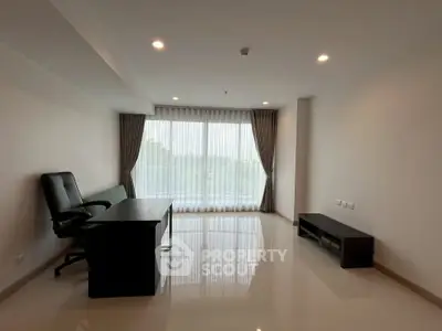 Spacious modern living room with large window and sleek furniture