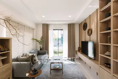 Modern living room with stylish decor, large window, and cozy seating area.