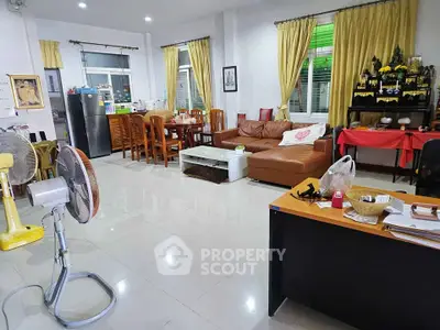 Spacious living room with modern furniture and dining area, perfect for family gatherings.