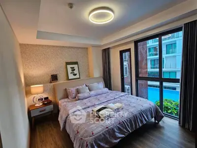 Cozy bedroom with modern decor and large window overlooking pool area in luxury apartment.
