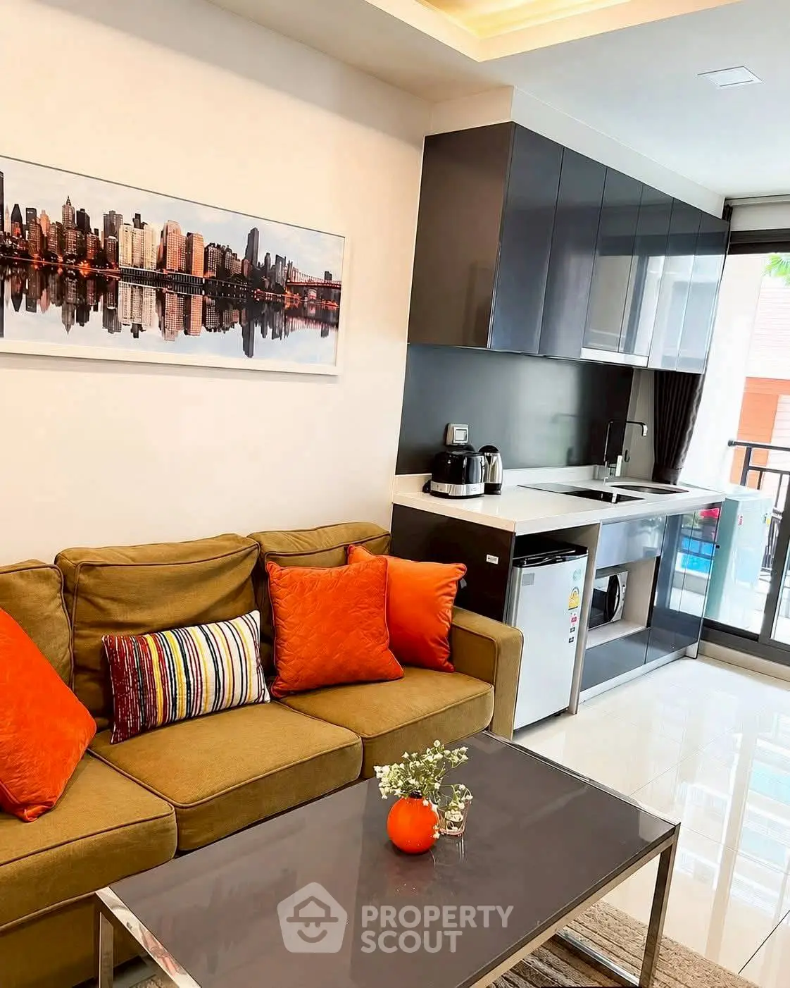 Modern living room with stylish kitchen and vibrant decor in a cozy apartment.