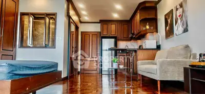 Chic studio apartment with modern kitchen and cozy living area, perfect for urban living.
