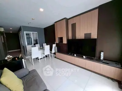 Modern living room with sleek entertainment center and dining area