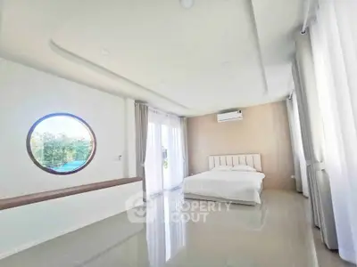 Spacious modern bedroom with large windows and minimalist decor