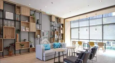 Modern living room with stylish shelving and large windows in a bright apartment.