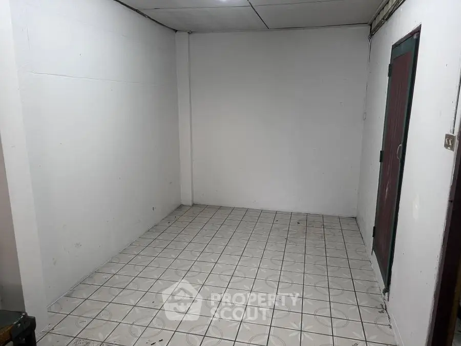 Minimalist empty room with tiled floor and white walls, ready for customization.