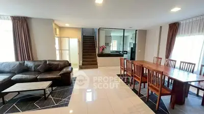 Spacious modern living and dining area with sleek design and ample natural light.