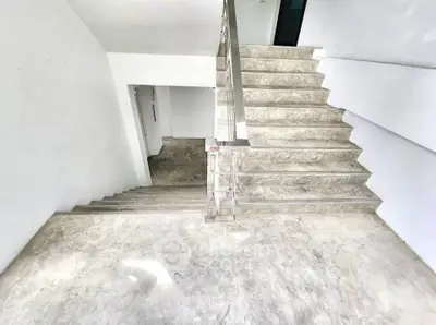 Modern staircase with sleek metal railing in a minimalist interior
