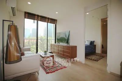 Modern living room with city view, stylish decor, and natural light