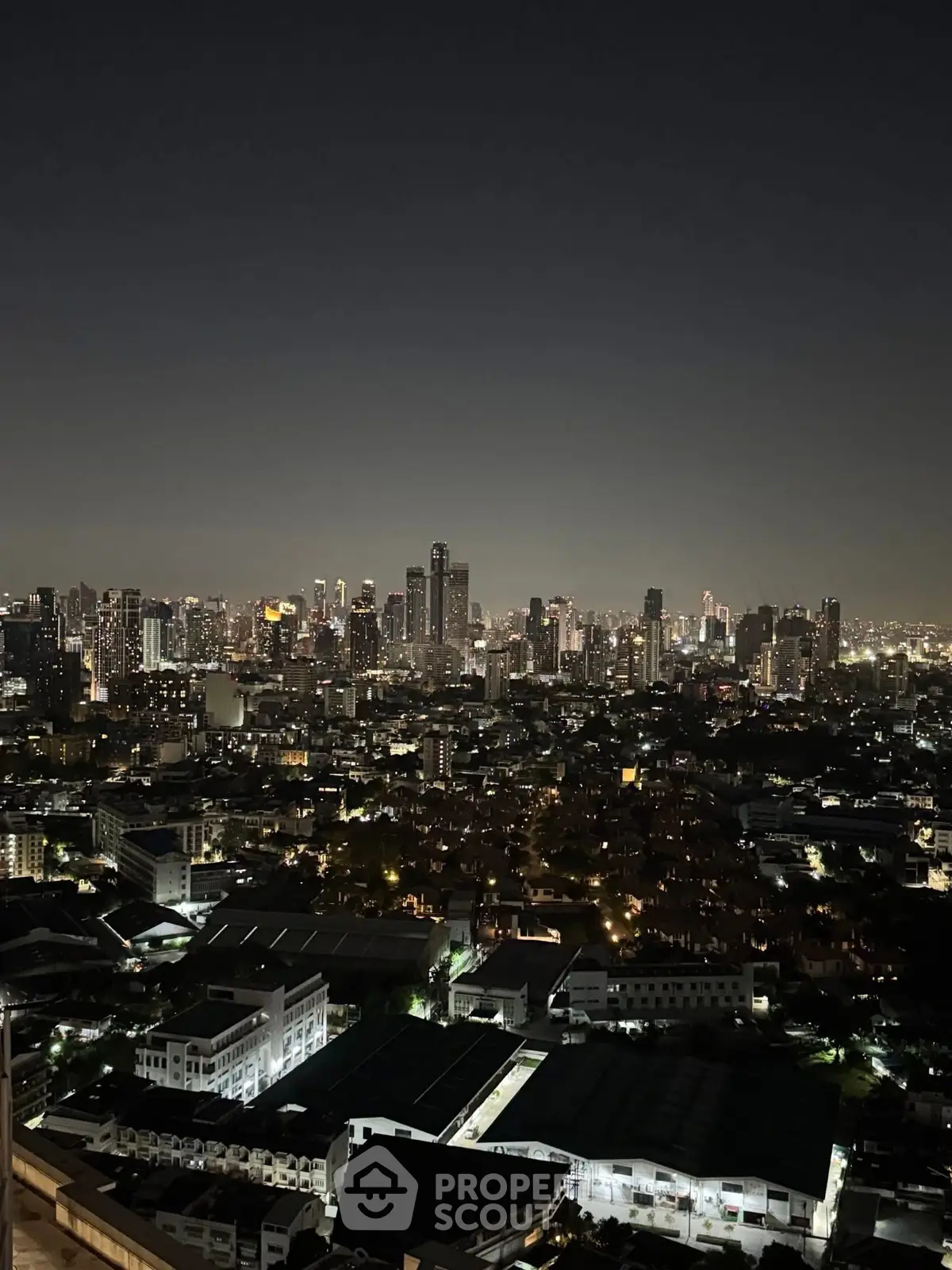 Stunning night cityscape view from high-rise apartment balcony