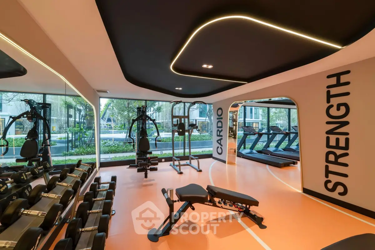 Modern gym with cardio and strength equipment, large windows, and sleek design.