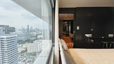 Modern bedroom with stunning city view from high-rise apartment window.