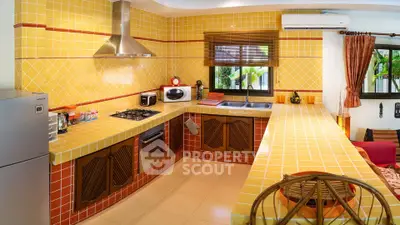 Charming kitchen with vibrant yellow tiles and modern appliances, perfect for culinary enthusiasts.